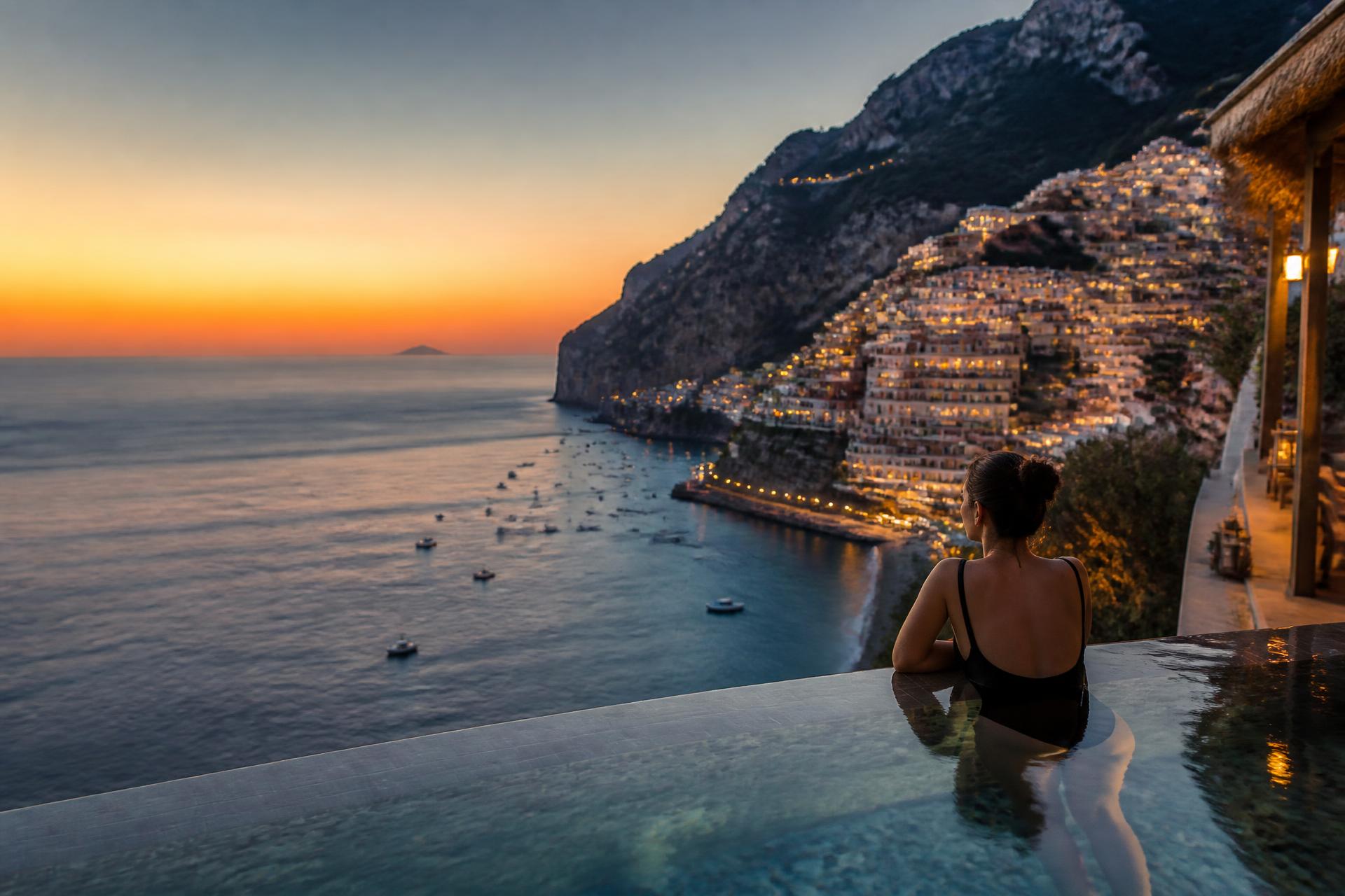 Traveler overlooking the Amalfi Coast at sunset